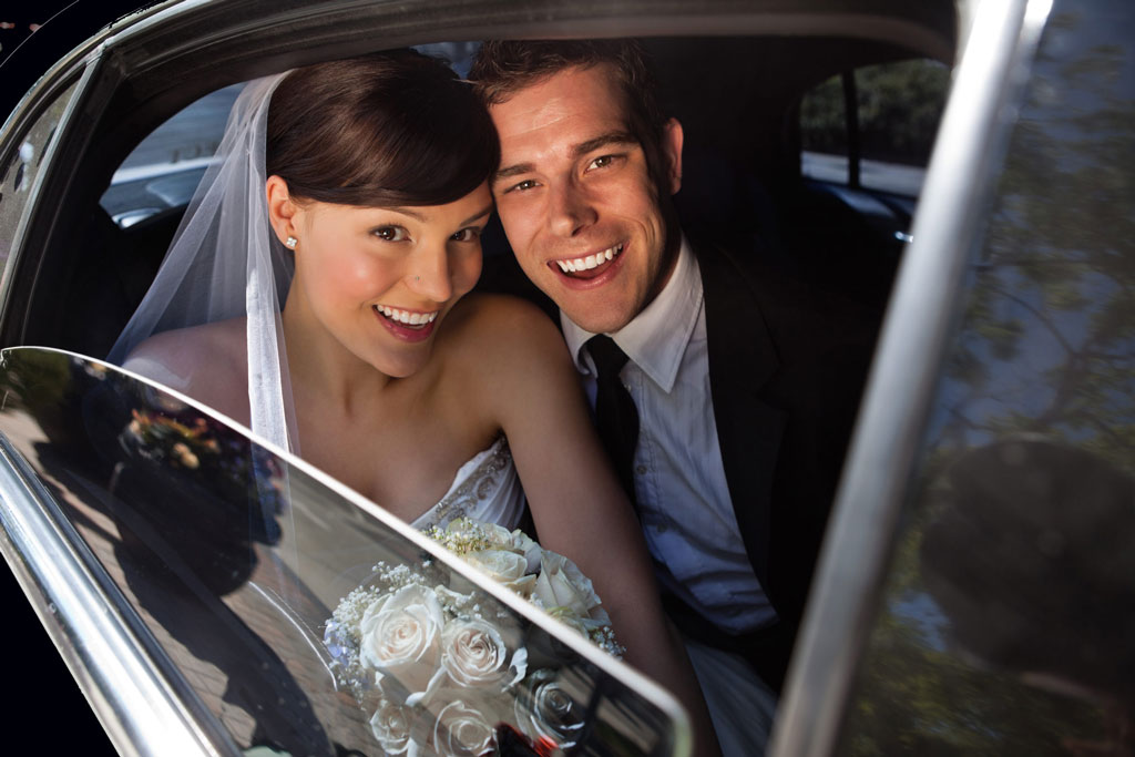 Bride and groom riding in a Seattle limo service vehicle after their wedding